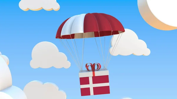 Box with national flag of Denmark falls with a parachute. 3D rendering — стокове фото