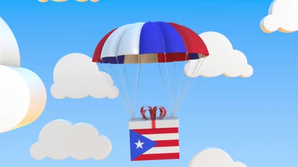 Box med nationell flagga Puerto Rico faller med en fallskärm. Loopable konceptuell 3D-animation — Stockvideo