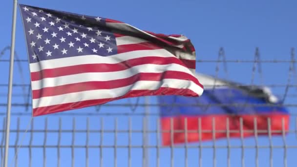 Fahnen der USA und Russlands schwenkend, die durch Stacheldrahtzäune voneinander getrennt sind. Konfliktbezogene loopable konzeptionelle 3D-Animation — Stockvideo