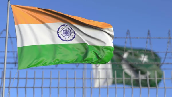 Zwaaiende vlaggen van India en Pakistan gescheiden door prikkeldraad hek. Conflictgerelateerde conceptuele 3d-weergave — Stockfoto