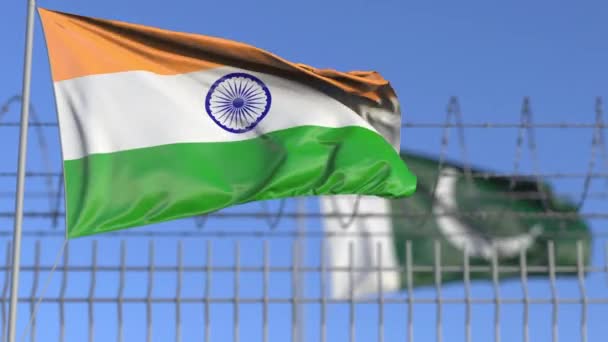 Waving flags of India and Pakistan separated by barbed wire fence. Conflict related loopable conceptual 3D animation — Stock Video