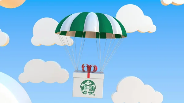 Logotipo STARBUCKS em movimento caixa se move sob paraquedas. Renderização 3D editorial — Fotografia de Stock