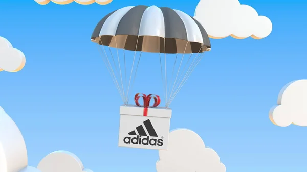 Κουτί με λογότυπο Adidas πέφτει με αλεξίπτωτο. Έκδοση 3d απόδοση — Φωτογραφία Αρχείου