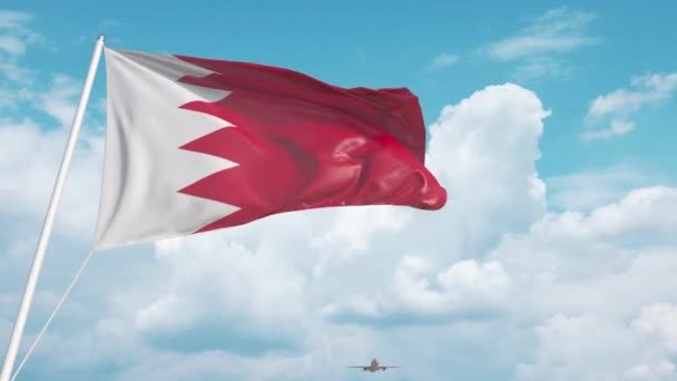 Aereo commerciale che atterra dietro la bandiera bahreinita. Turismo in Bahrein — Video Stock