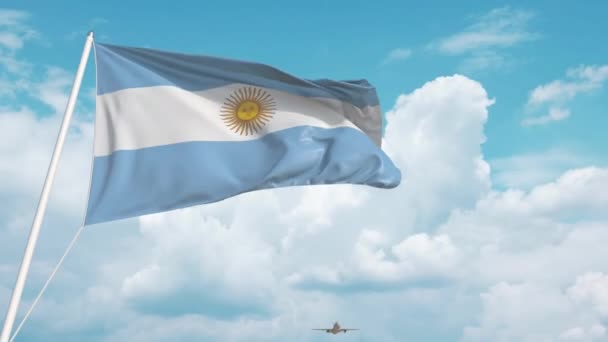 Samolot komercyjny lądujący za argentyńską flagą. Turystyka w Argentynie — Wideo stockowe