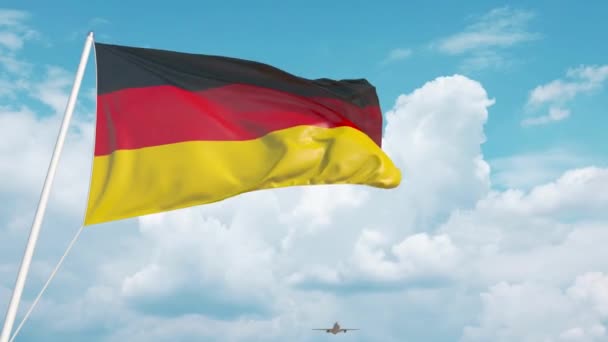 Авиалайнер приближается к германскому национальному флагу. Туризм в Германии — стоковое видео