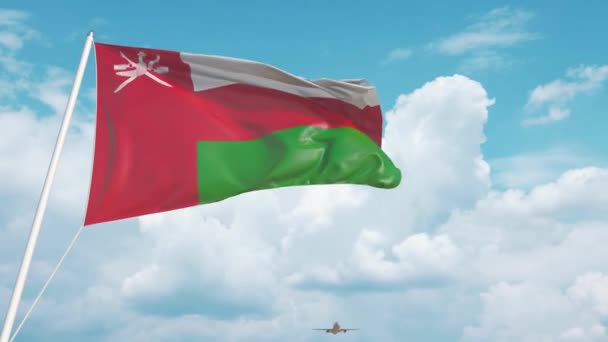 O avião aproxima-se da bandeira nacional de Omani. Turismo em Omã — Vídeo de Stock