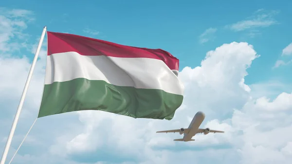 Avión comercial aterrizando detrás de la bandera nacional húngara. Turismo en Hungría. Renderizado 3D — Foto de Stock