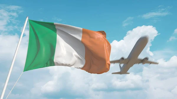 Commercial airplane landing behind the Irish national flag. Tourism in Ireland. 3D rendering — Stock Photo, Image