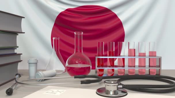 Japon bayrağı geçmişinde klinik laboratuvar ekipmanları. Japonya 'da sağlık ve tıbbi araştırmalar kavramsal animasyonla ilgilidir — Stok video