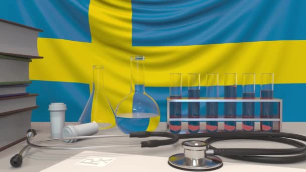Εργαστηριακός εξοπλισμός κλινικής σε Σουηδική σημαία υποβάθρου. Υγειονομική και ιατρική έρευνα στη Σουηδία — Αρχείο Βίντεο