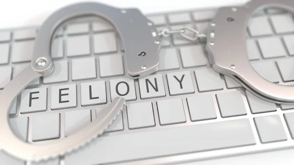 Handcuffs on keyboard with FELONY text. Computer crime related conceptual 3D rendering — 스톡 사진