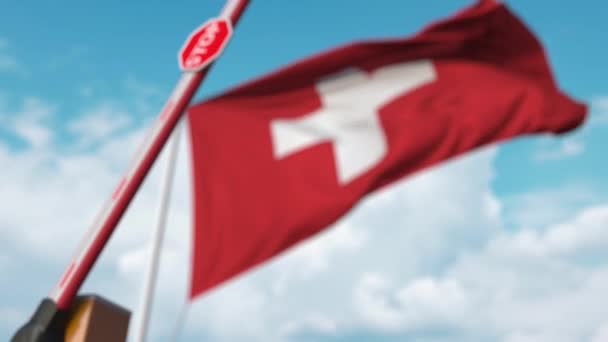 Closing boom barrier with stop sign against the Swiss flag. Restricted border crossing or certain ban in Switzerland — Stock Video