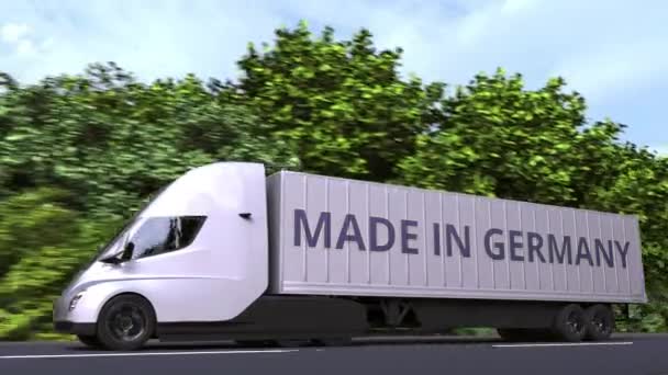 Camion semi-remorque électrique moderne avec texte MADE IN ALLEMAGNE sur le côté. Animation 3D en boucle liée à l'importation ou à l'exportation allemande — Video