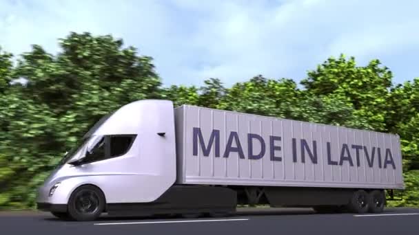Camion remorque avec texte MADE IN LATVIA sur le côté. Importation ou exportation lettone liée à l'animation 3D en boucle — Video