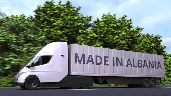 Сучасна електрична напівпричепна вантажівка з текстом "Made In Albania" збоку. Албанський імпорт або експорт пов'язані 3d рендеринга — стокове фото