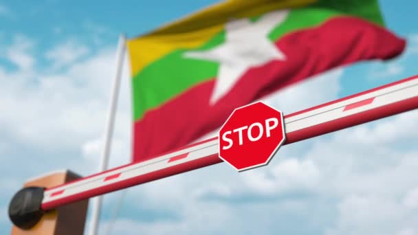 Opening boom barrier with stop sign against the Myanma flag. Free border crossing or lifting a ban in Myanmar — Stock Video