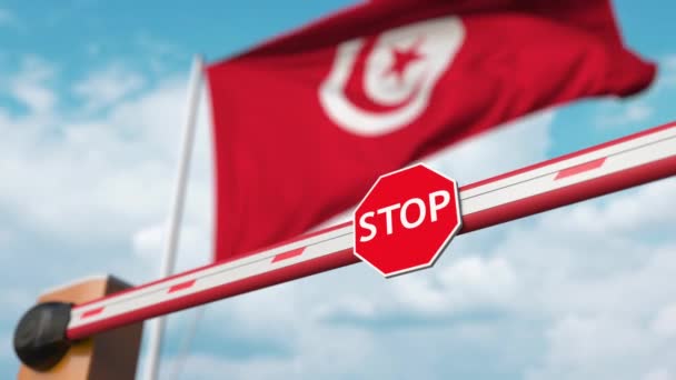 Opening boom barrier with stop sign against the Tunisian flag. Free border crossing or lifting a ban in Tunisia — Stock Video