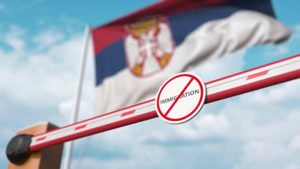 Opening boom barrier with stop immigration sign against the Serbian flag, immigration welcome center in Serbia — Stock Video