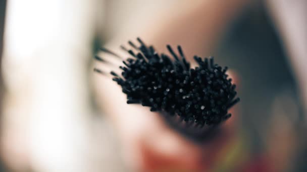 Dropping black spaghetti on wooden table, slow motion close-up shot — Stock Video