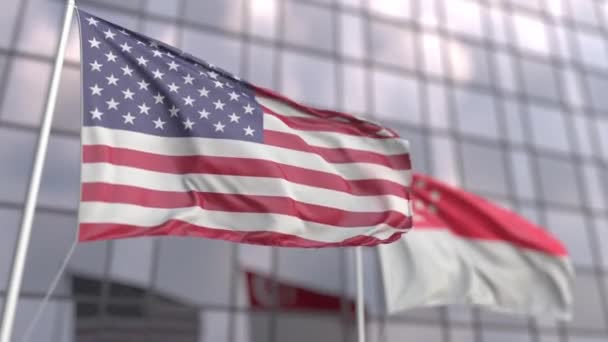 Waving flags of the United States and Singapore in front of a modern skyscraper — Stock Video