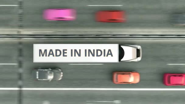 Bovenaanzicht vanuit de lucht van trailer trucks met Made In India tekst rijden langs de weg. Indiase business gerelateerde loopable 3d animatie — Stockvideo