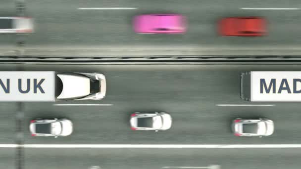 Camiones remolque con texto MADE IN UK conduciendo a lo largo de la carretera. Animación 3D loopable relacionada con el negocio británico — Vídeos de Stock