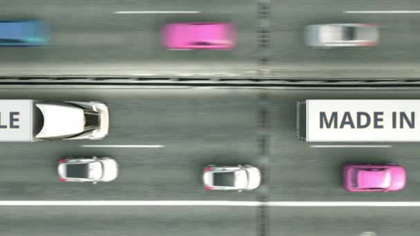 Vista aérea de camiones semirremolques con texto MADE IN CHILE conduciendo por la carretera. Animación 3D loopable relacionada con el negocio chileno — Vídeos de Stock