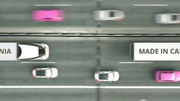 Camiones remolque con texto MADE IN CALIFORNIA conduciendo por la carretera. Animación 3D loopable relacionada con el negocio — Vídeo de stock