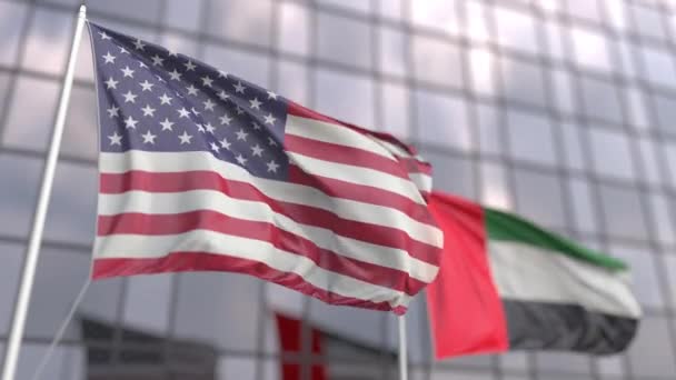 Ondeando banderas de los EE.UU. y los Emiratos Árabes Unidos frente a un rascacielos — Vídeo de stock