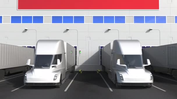 Electric semi-trailer trucks at warehouse loading dock with flag of VIETNAM. Vietnamese logistics related conceptual 3D animation — Stock Video