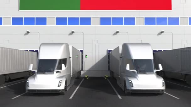 Electric trailer trucks at warehouse loading bay with flag of PORTUGAL. Portuguese logistics related conceptual 3D animation — Stock Video