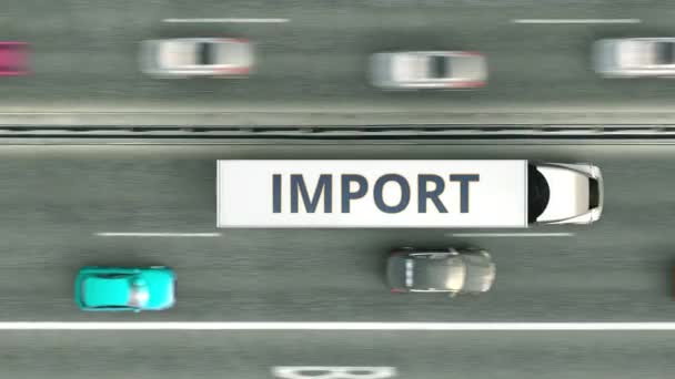 Vue aérienne du haut vers le bas des camions-remorques avec texte IMPORT conduisant le long de l'autoroute. Animation 3D bouclable — Video