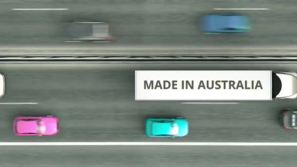 Трейлеры с надписью MADE IN AUSTRALIA едут по шоссе. Цифровая 3D анимация, связанная с бизнесом в Австралии — стоковое видео