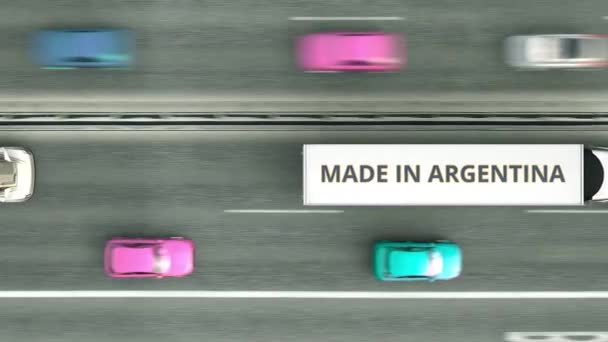 带有MADE IN ARGENTINA文字的拖车卡车沿着公路行驶。阿根廷企业易受攻击的3D动画 — 图库视频影像