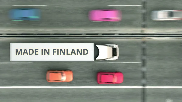 Vedere aeriană de sus în jos a camionului remorcii cu text MADE IN FINLAND de-a lungul drumului. Finlandeză de afaceri legate de redare 3D — Fotografie, imagine de stoc