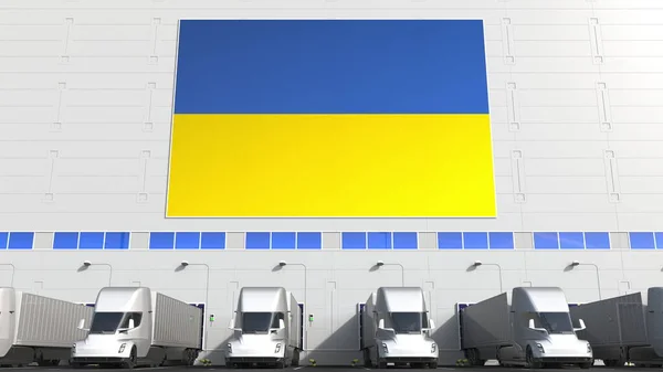 Electric semi-trailer trucks at warehouse loading dock with flag of UKRAINE. Ukrainian logistics related conceptual 3D rendering — Stock Photo, Image