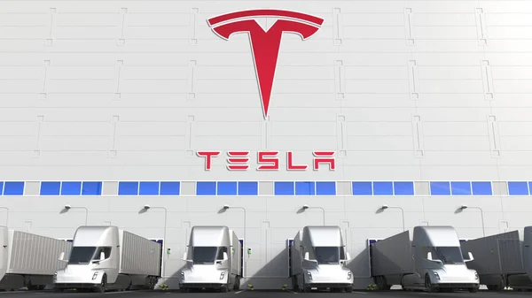 Elektro-Sattelschlepper auf der Ladefläche eines Lagers mit Tesla-Logo an der Wand. Leitartikel 3D-Rendering — Stockfoto