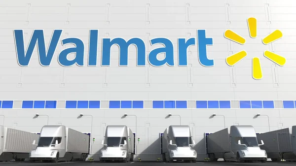 Electric semi-trailer trucks at warehouse loading bay with WALMART logo on the wall. Editorial 3D rendering — Stock Photo, Image