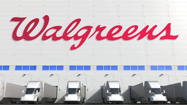 Elektromos pótkocsik a raktár rakodóterében Walgreens logóval a falon. Szerkesztőségi 3D-s renderelés — Stock Fotó