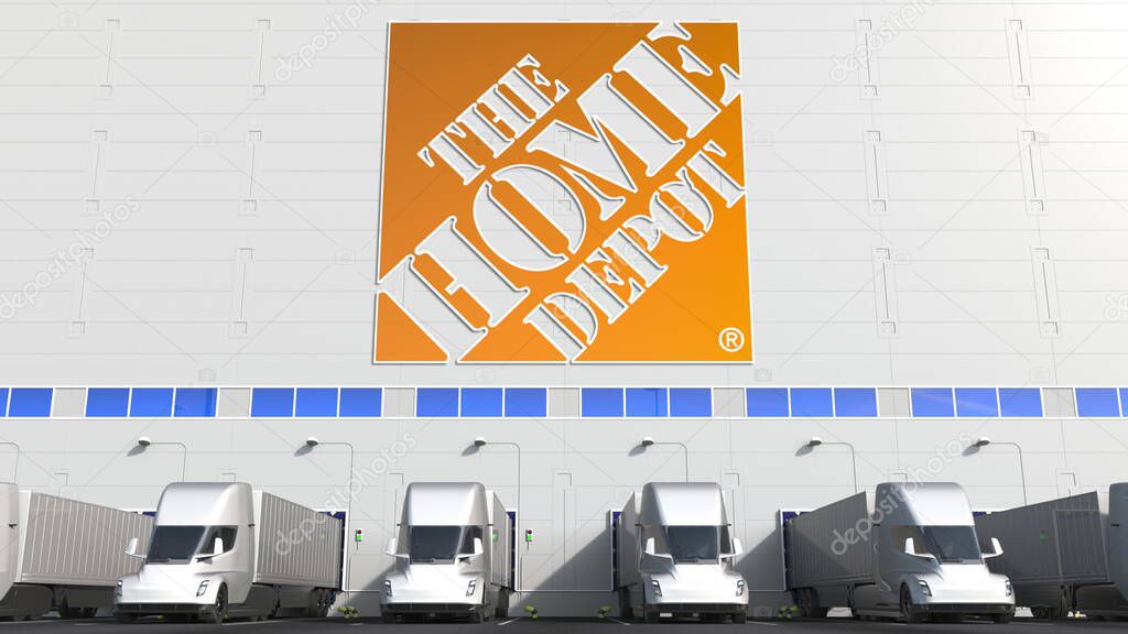 Trailer trucks at warehouse loading bay with logo on the wall. Editorial 3D