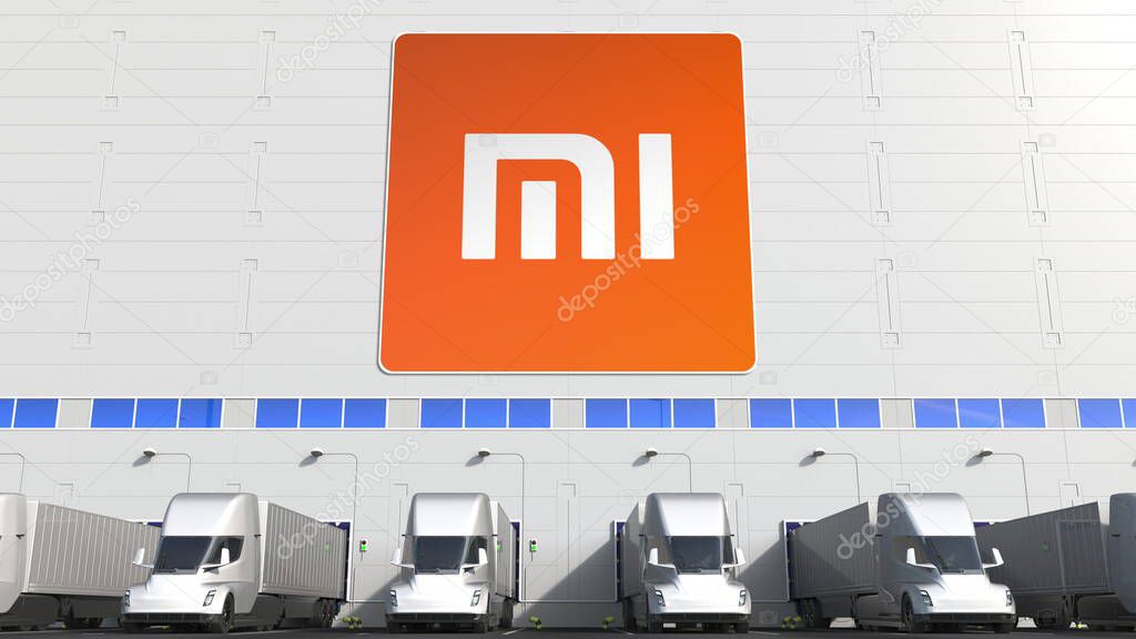 Trailer trucks at warehouse loading bay with logo on the wall. Editorial 3D