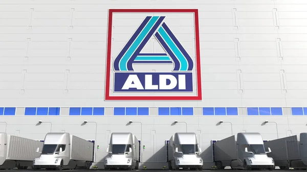 Elektrische opleggers op magazijn laadperron met ALDI logo op de muur. Redactionele 3D-weergave — Stockfoto