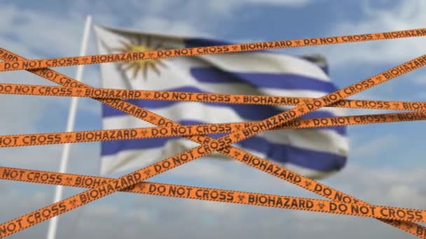 Biohazard restriction tape lines against the Uruguayan flag. Restricted entry or quarantine in Uruguay. Conceptual looping 3D animation — Stock Video