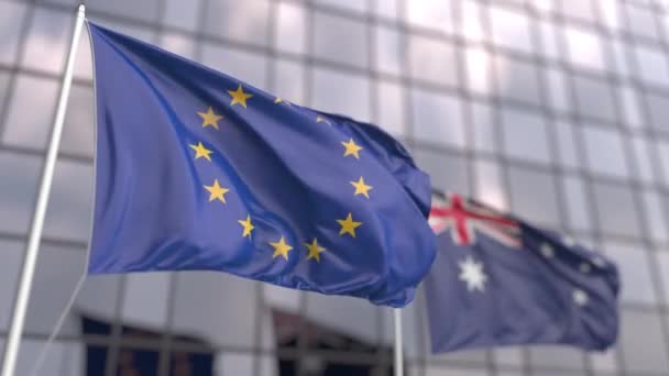 Waving flags of the EU and Australia near modern skyscraper — Stock Video