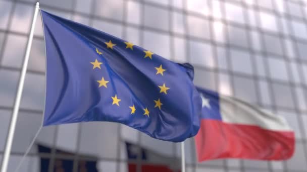 Waving flags of the European Union and Chile in front of a modern skyscraper — Stock Video