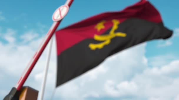 Closed boom gate with STOP CORONAVIRUS sign on the Angolan flag background. Quarantine in Angola — Stock Video