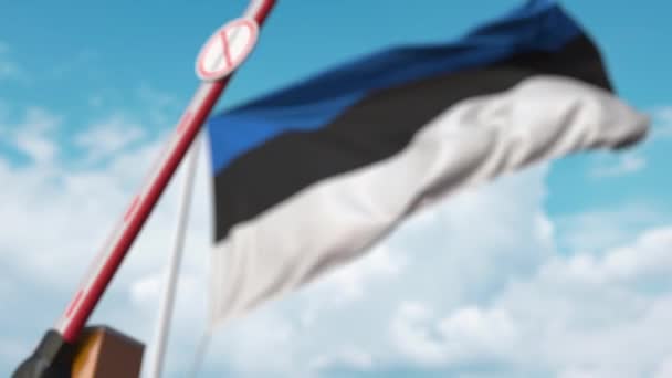 Closing boom barrier with STOP CORONAVIRUS sign against the Estonian flag. Quarantine in Estonia — Stock Video