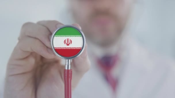 Doctor uses stethoscope with the Iranian flag. Healthcare in Iran — Stock Video