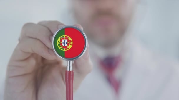 Doctor uses stethoscope with the Portuguese flag. Healthcare in Portugal — Stock Video